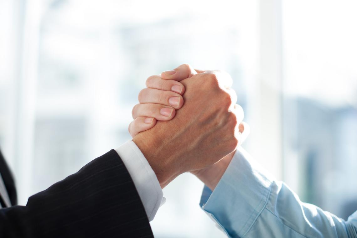 Close-up of two clasped hands of businessmen